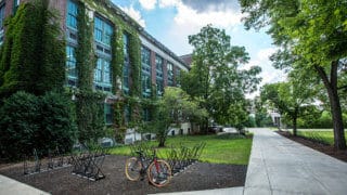 ivy-covered university building with bicycle parked in front