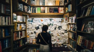 girl looking at bulletin board in bookstore